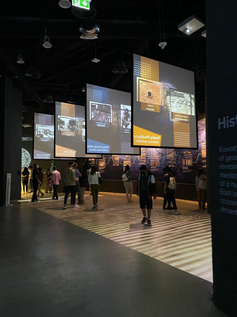 Suspended AV screens over wall based displays