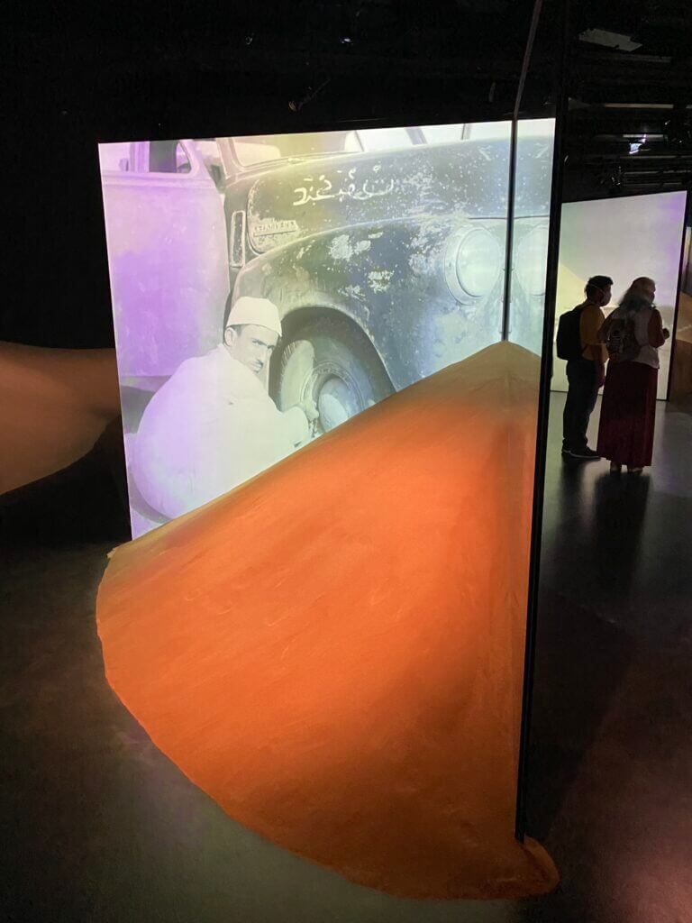 Shards of glass with projected images set into sand hills